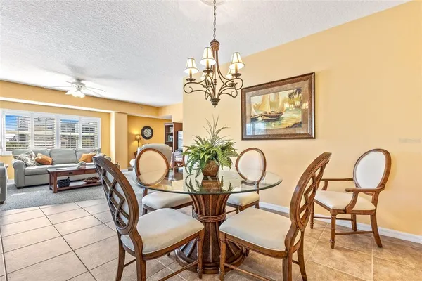 a view of a dining room with furniture wooden floor and chandelier