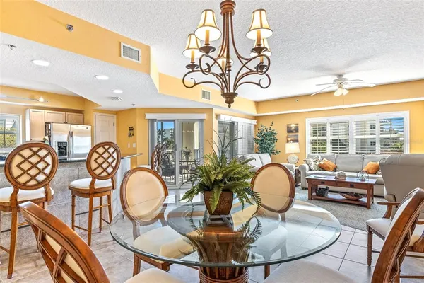a dining room with furniture and a floor to ceiling window