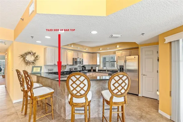 a large kitchen with granite countertop a large window and a counter space