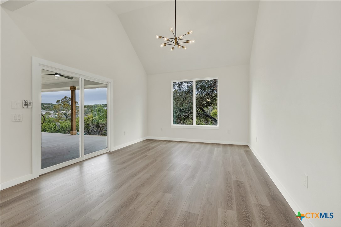 328 Compass Rose Spring Branch, TX 78070 - Photo 18 of 48 an empty room with wooden floor and windows