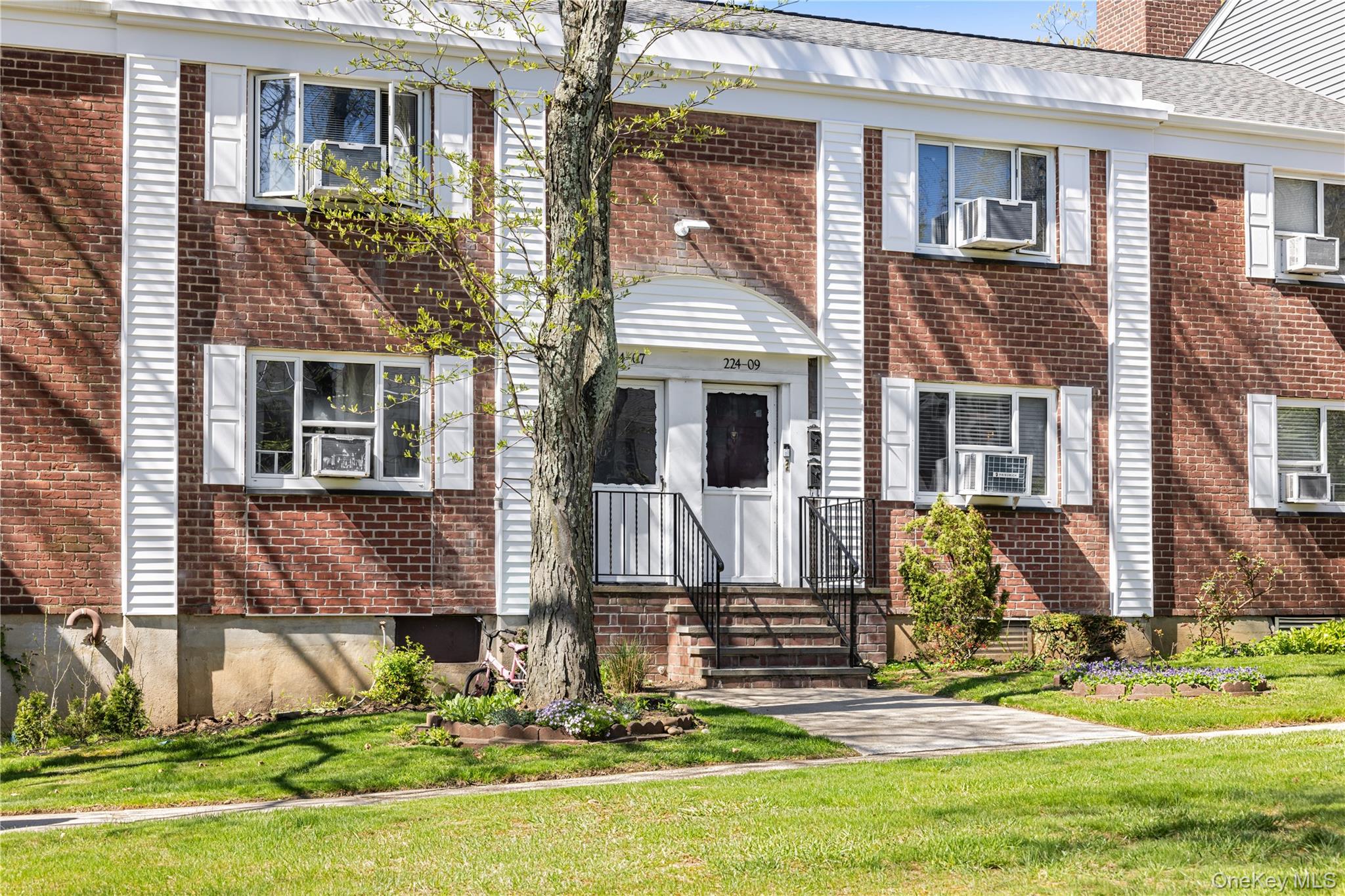 224-09 Manor Road, Unit LOWER) 2408 Queens, NY 11427 - Photo 1 of 20 front view of house with a yard