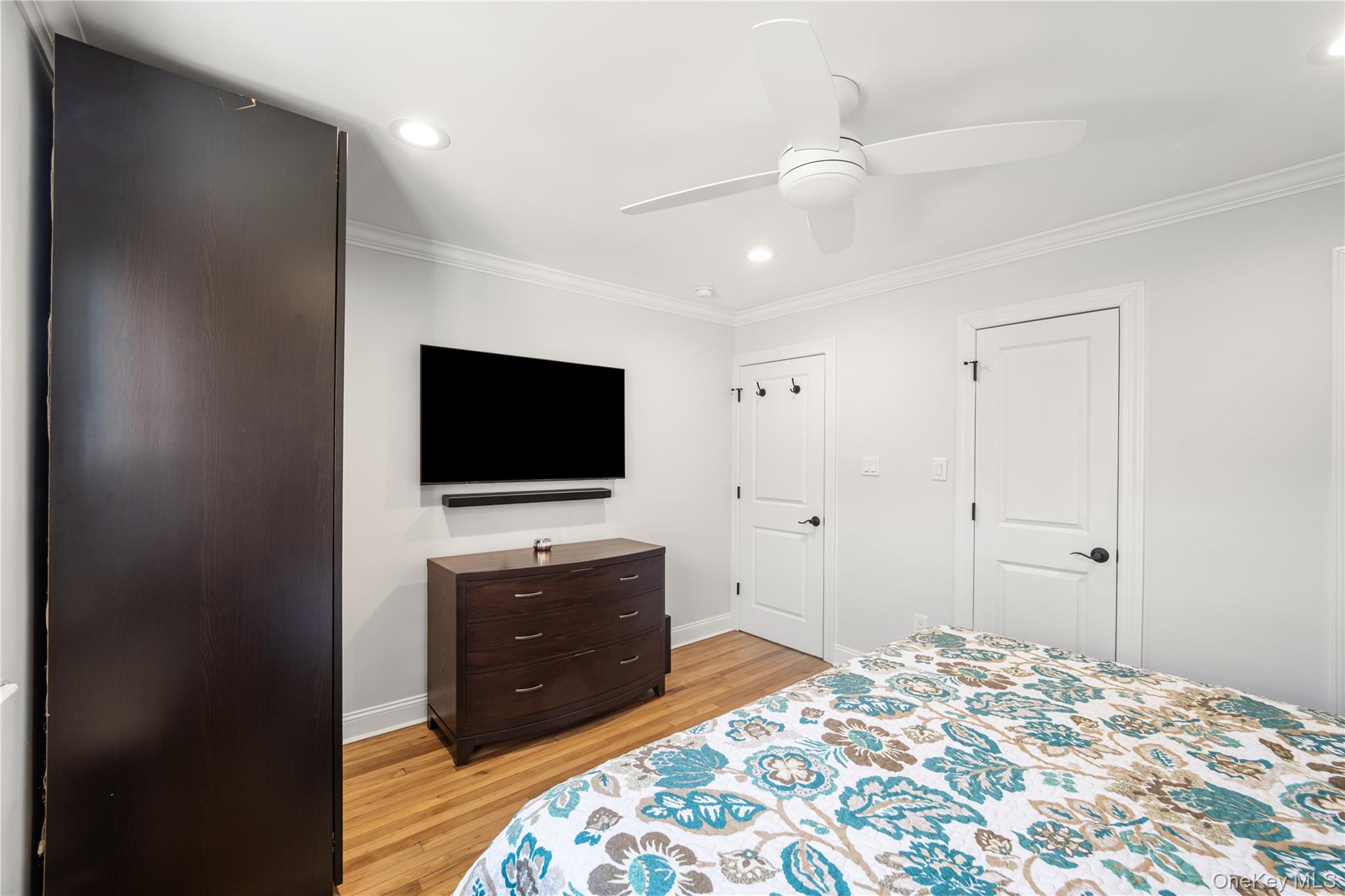 224-09 Manor Road, Unit LOWER) 2408 Queens, NY 11427 - Photo 13 of 20 a living room with a flat screen tv and a dresser