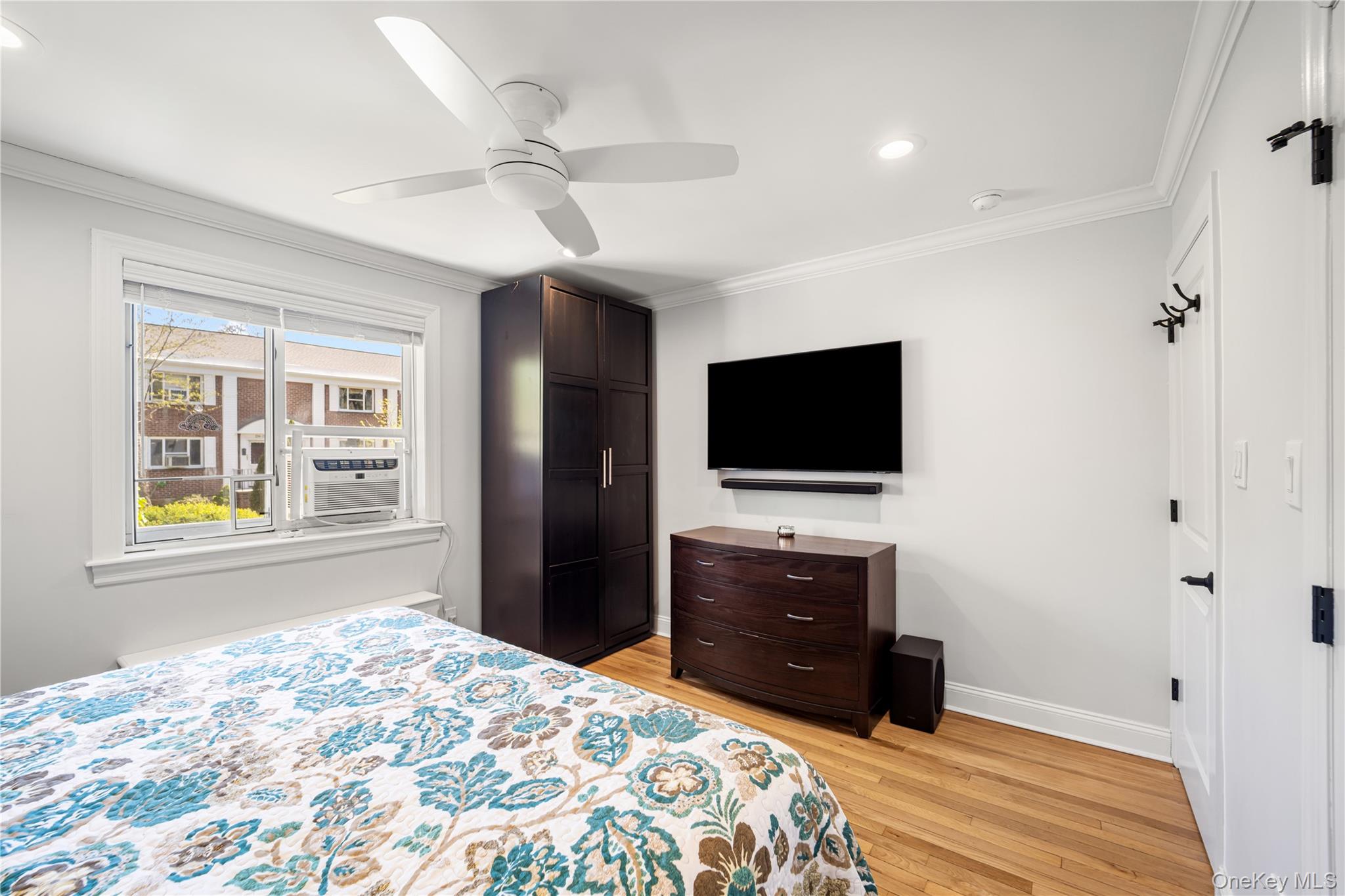 224-09 Manor Road, Unit LOWER) 2408 Queens, NY 11427 - Photo 14 of 20 a bedroom with a bed and a flat screen tv