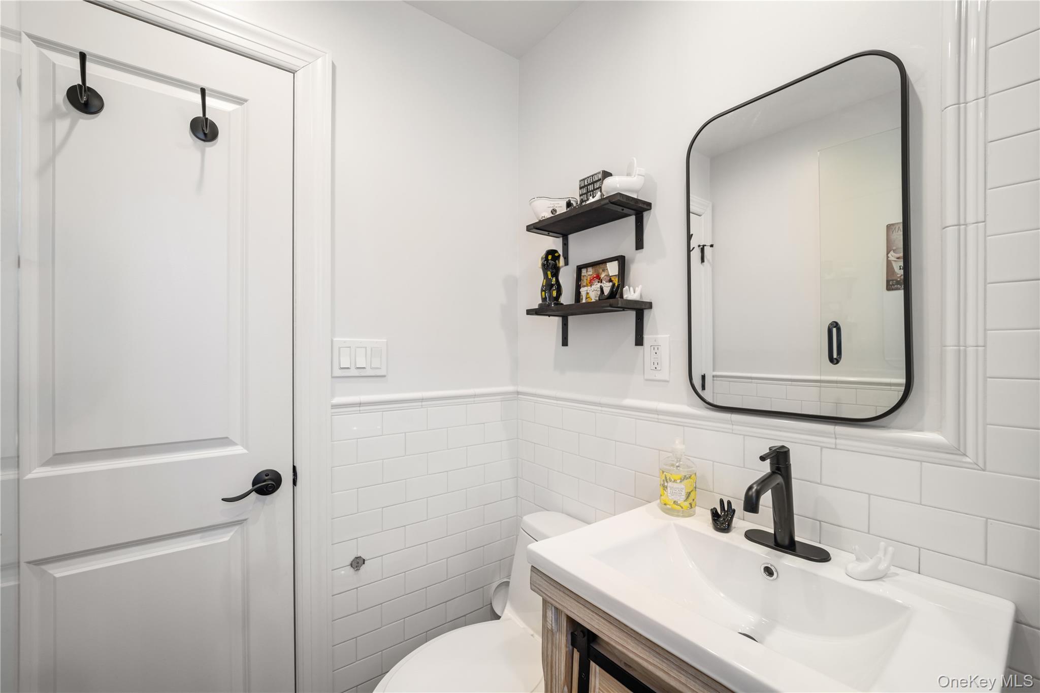 224-09 Manor Road, Unit LOWER) 2408 Queens, NY 11427 - Photo 19 of 20 a bathroom with a sink toilet and shower