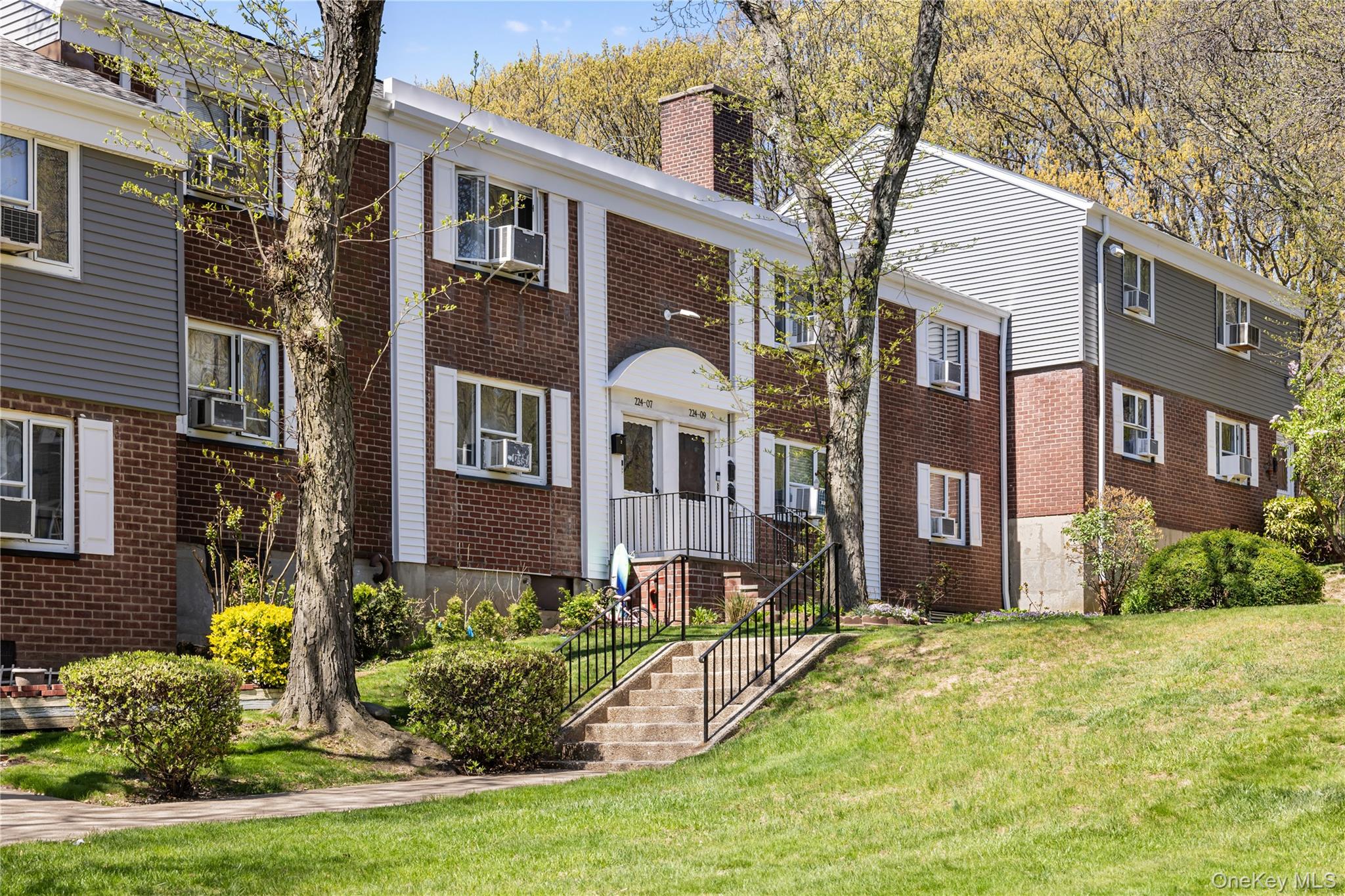 224-09 Manor Road, Unit LOWER) 2408 Queens, NY 11427 - Photo 2 of 20 a front view of a house with a yard