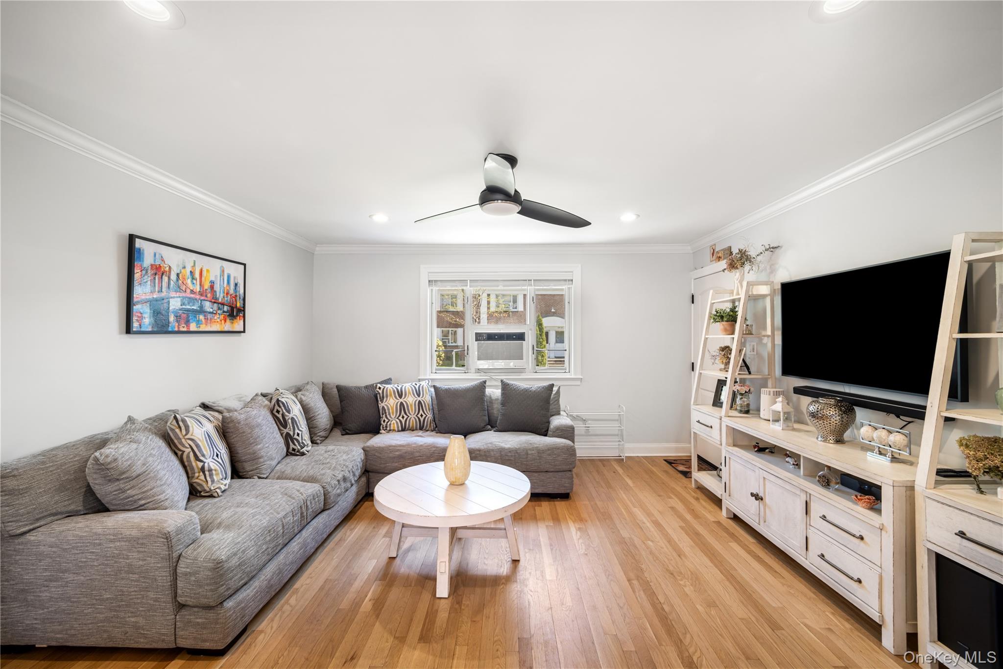 224-09 Manor Road, Unit LOWER) 2408 Queens, NY 11427 - Photo 5 of 20 a living room with furniture and a flat screen tv