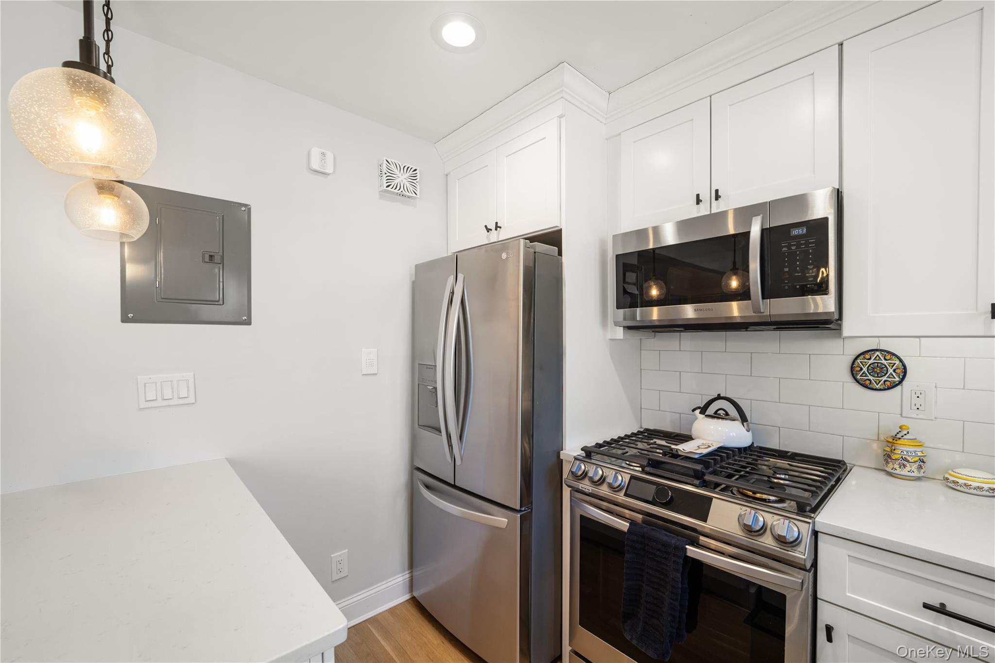 224-09 Manor Road, Unit LOWER) 2408 Queens, NY 11427 - Photo 8 of 20 a kitchen with stainless steel appliances a stove a refrigerator and a microwave