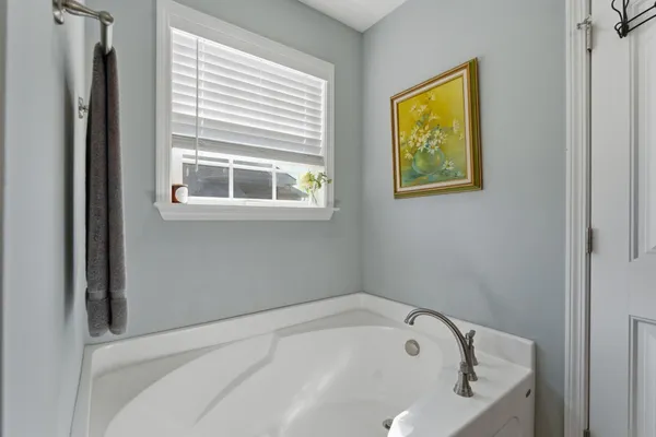 a white bath tub sitting next to a window