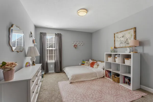 a bedroom with furniture and a wooden floor