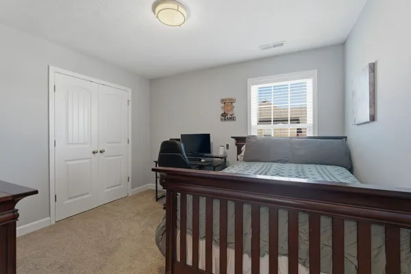 a view of a livingroom with workspace and a window