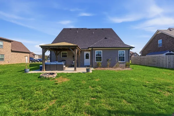 a front view of a house with a yard table and chairs