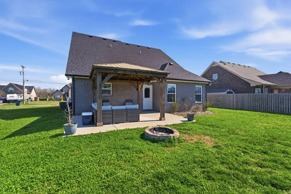 a front view of a house with a yard table and chairs