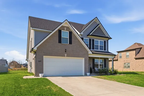 a front view of a house with a yard and garage