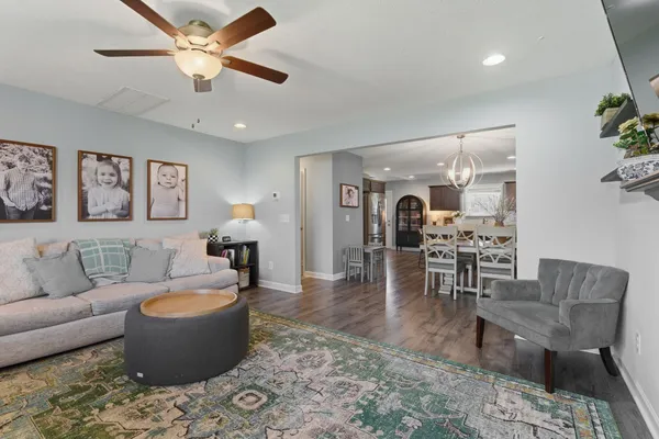 a living room with furniture and view of kitchen