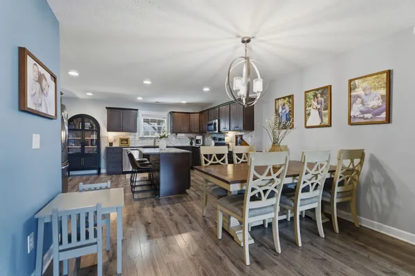 a living room with lots of furniture and kitchen view