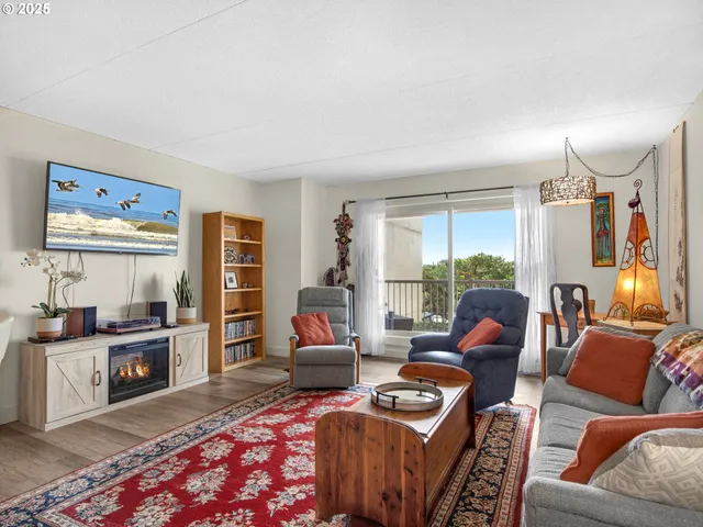 a living room with furniture a rug a lamp and a window