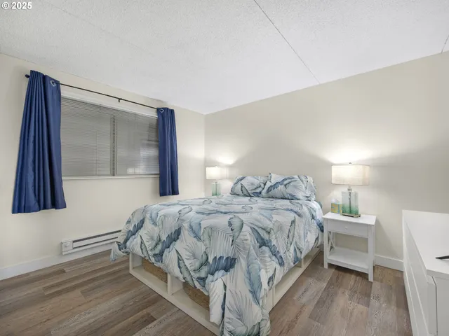 a bedroom with a bed and a night stand