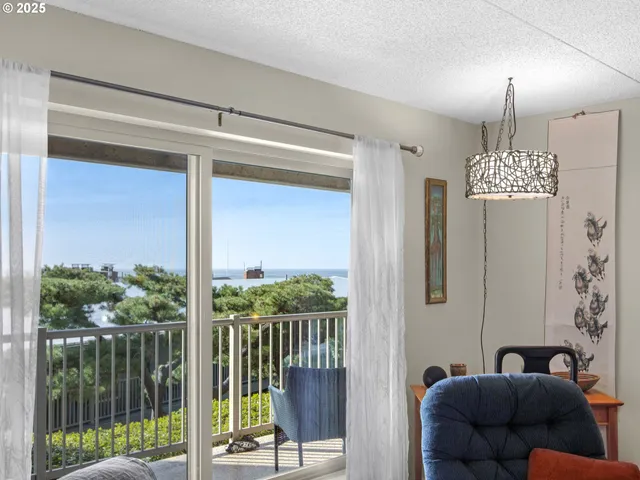a living room with furniture and a floor to ceiling window