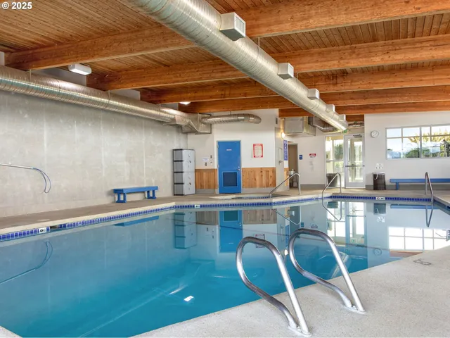 a kitchen with a table chairs sink and cabinets