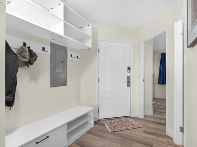 a hallway with front door and wooden floor