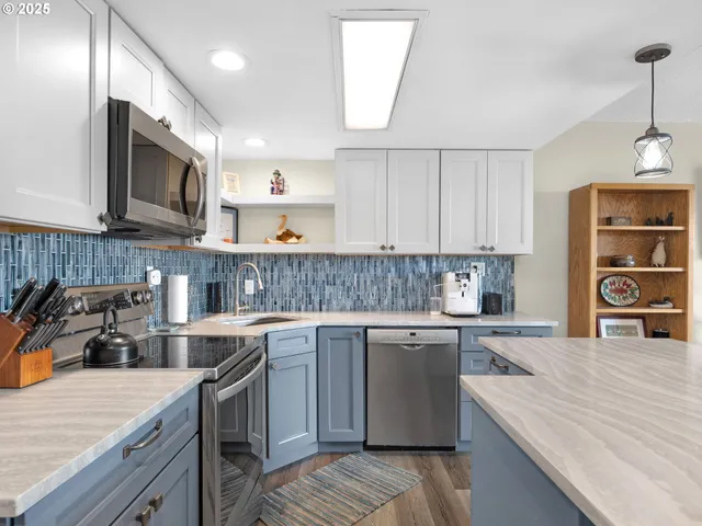 a kitchen with stainless steel appliances granite countertop a sink stove and refrigerator