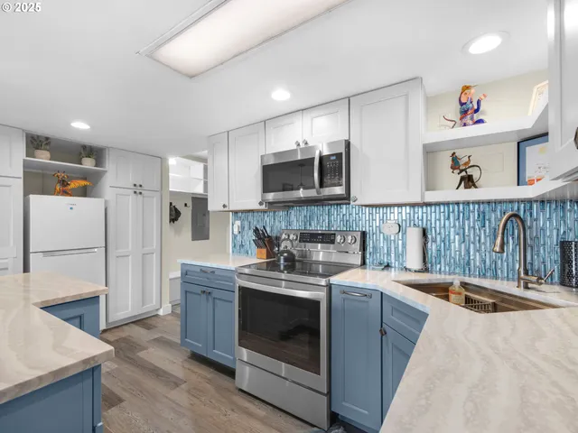 a kitchen with a sink a stove and cabinets
