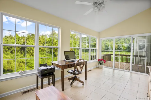a living room filled with furniture and a large window