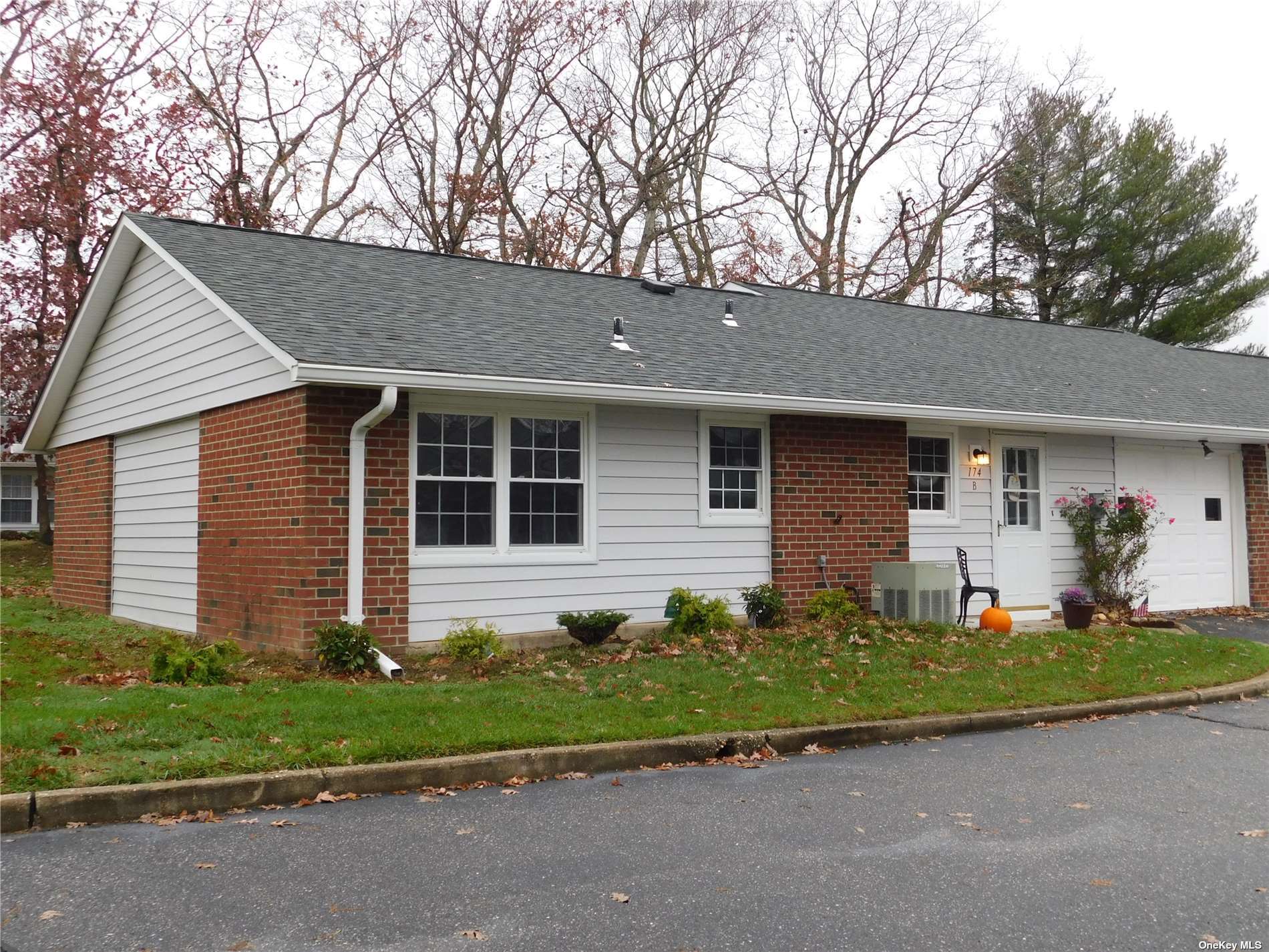 174 Ventry Court, Unit B Ridge, NY 11961 - Photo 1 of 1 a front view of a house with a garden and yard
