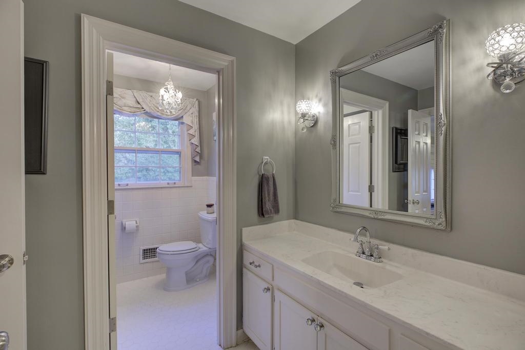 2289 Kirby Road Memphis, TN 38119 - Photo 24 of 35 a bathroom with a toilet sink and mirror