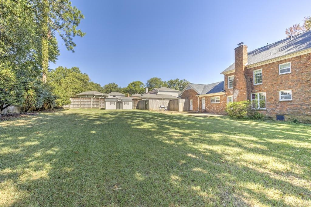 2289 Kirby Road Memphis, TN 38119 - Photo 32 of 35 a view of a big house with a big yard and large trees