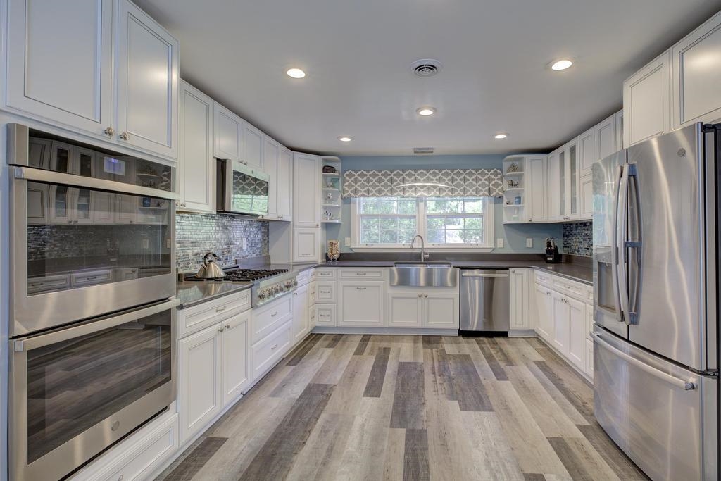 2289 Kirby Road Memphis, TN 38119 - Photo 7 of 35 a large kitchen with stainless steel appliances granite countertop a stove a sink and a refrigerator