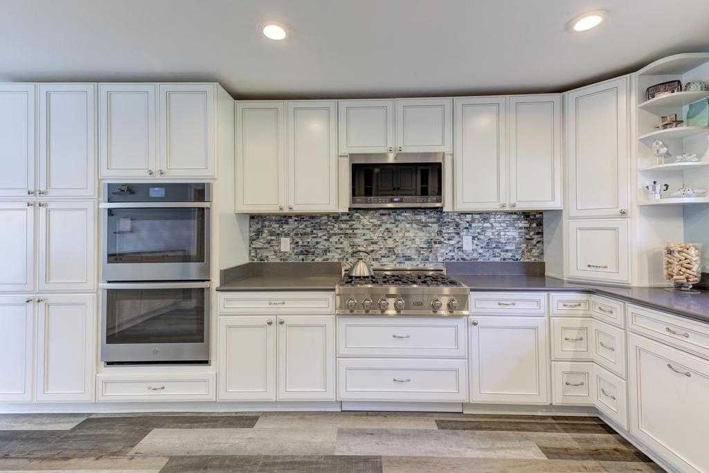 2289 Kirby Road Memphis, TN 38119 - Photo 8 of 35 a kitchen with white cabinets and stainless steel appliances