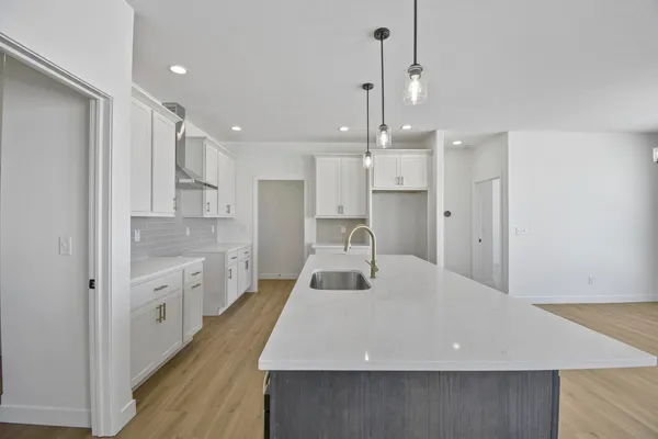 a large kitchen with kitchen island a sink stainless steel appliances and cabinets
