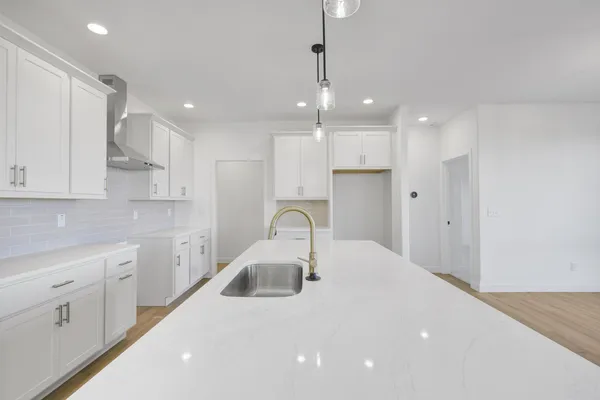 a kitchen with kitchen island a sink stainless steel appliances and cabinets