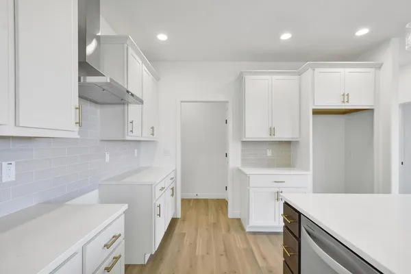a kitchen with stainless steel appliances a sink a stove a refrigerator and cabinets