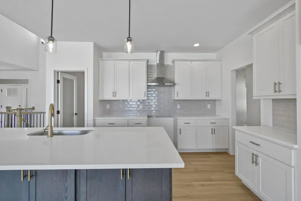 a large kitchen with kitchen island a sink stainless steel appliances and cabinets