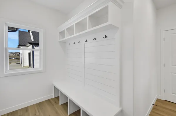 a view of storage and utility room with wooden floor