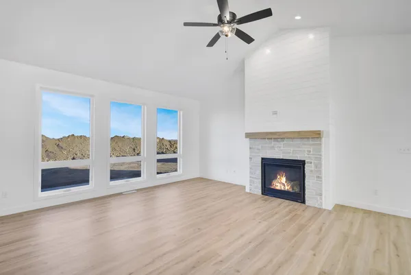 a view of an empty room with a fireplace and a window