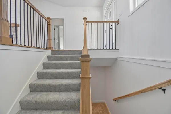 a view of staircase with white walls and a window