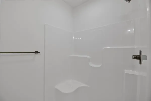 an empty room with a ceiling fan and a window