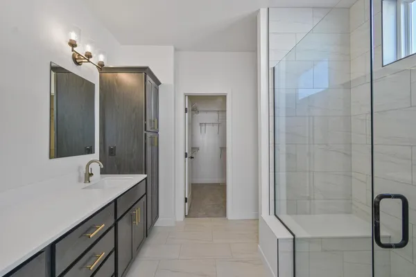 a bathroom with a double vanity sink a shower and a mirror