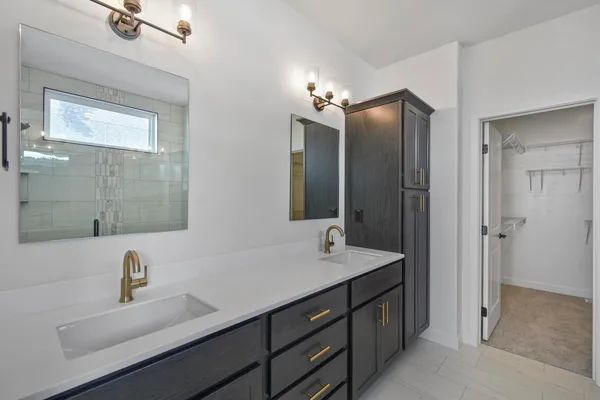 a bathroom with a double vanity sink a and mirror