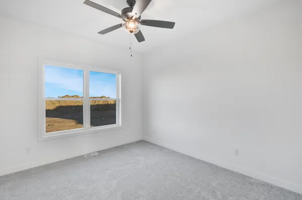 an empty room with a empty space and a ceiling fan