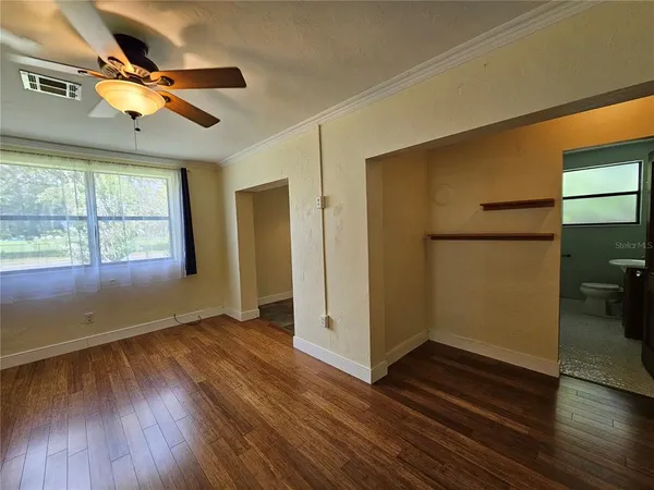 wooden floor in an empty room with a window