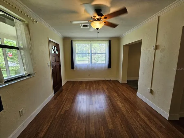 wooden floor in an empty room with a window