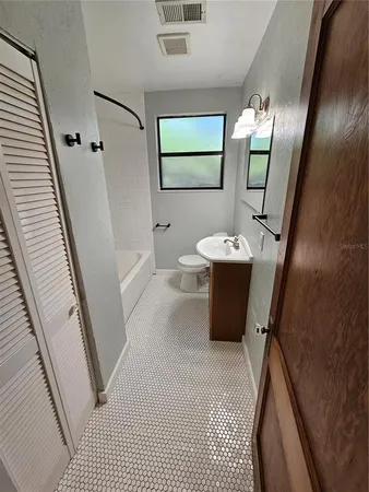 a bathroom with a sink a mirror and a shower