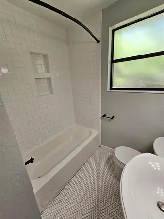a bathroom with a toilet and a bathtub