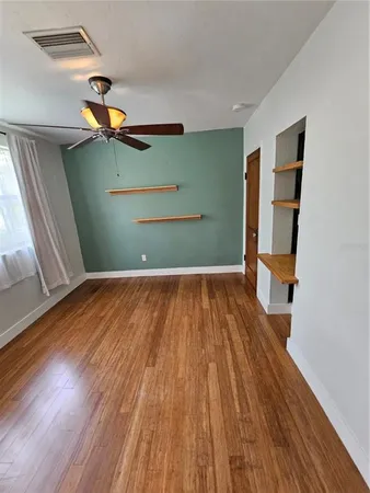 a view of a room with wooden floor staircase and windows