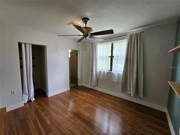 wooden floor in an empty room with a window