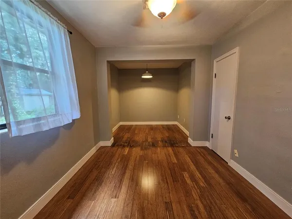 a view of a room with wooden floor and bench